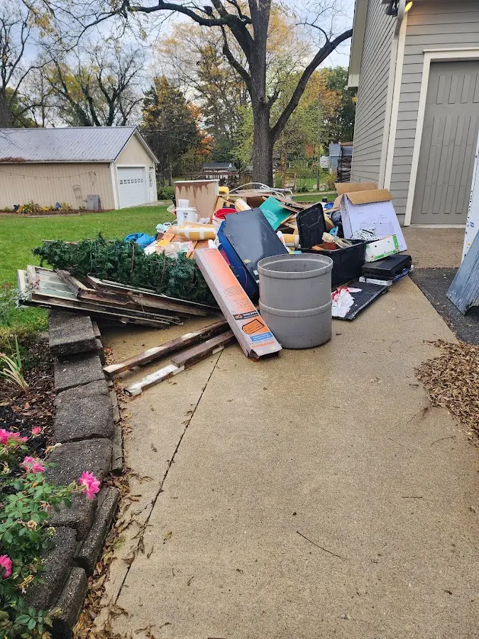 Dumpster being loaded with debris for Roofing Dumpster Rental in Livingston